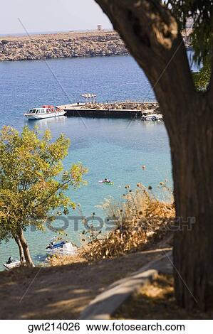 High angle view of boats at the dock, Lindos, Rhodes, Dodecanese Islands, Greece View Large Photo Image Stock Photograph - High angle view of boats at the dock, Lindos, Rhodes, Dodecanese Islands, Greece. Fotosearch