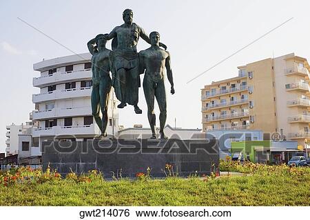 Low angle view of a monument with buildings in the background, Rhodes, Dodecanese Islands, Greece View Large Photo Image Stock Photograph - Low angle view of a monument with buildings in the background, Rhodes, Dodecanese Islands, Greece. Fotosearch