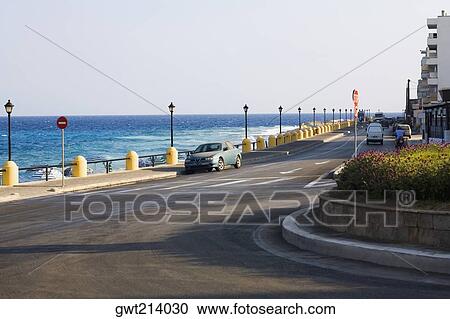 Stock Image - Road at the seaside, Rhodes, Dodecanese Islands, Greece. Fotosearch