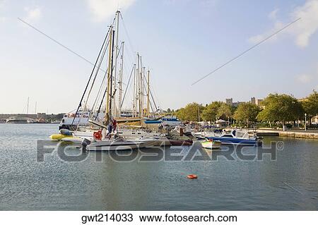 Sailboats at a harbor, Rhodes, Dodecanese Islands, Greece View Large Photo Image Stock Image - Sailboats at a harbor, Rhodes, Dodecanese Islands, Greece. Fotosearch