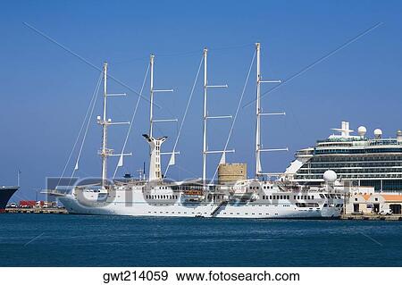 Stock Photo - Ships at a harbor, Mandraki Harbor, Rhodes, Dodecanese Islands, Greece. Fotosearch