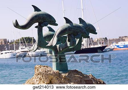 Statues at the seaside, Mandraki Harbor, Rhodes, Dodecanese Islands, Greece View Large Photo Image Stock Image - Statues at the seaside, Mandraki Harbor, Rhodes, Dodecanese Islands, Greece. Fotosearch