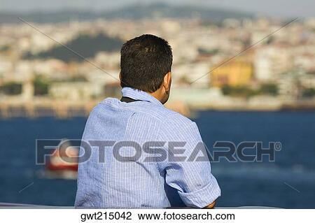 Rear view of a mature man looking at a view, Athens, Greece View Large Photo Image Stock Image - Rear view of a mature man looking at a view, Athens, Greece. Fotosearch