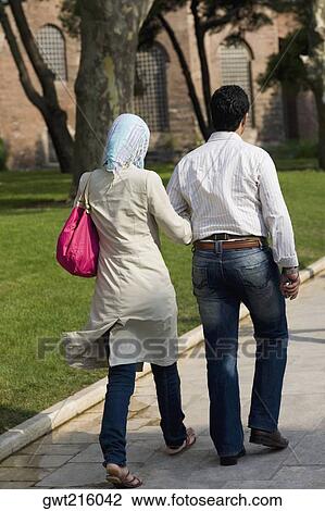 Rear View Of A Couple Walking With Their Arm In Arm Istanbul Turkey Stock Image Gwt Fotosearch