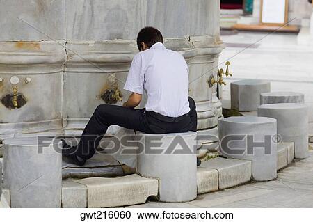 Rear view of a man filling a bag with water from a faucet, Istanbul, Turkey View Large Photo Image Stock Image - Rear view of a man filling a bag with water from a faucet, Istanbul, Turkey. Fotosearch