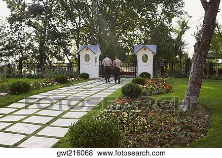 Rear view of two men moving towards a gate, Istanbul, Turkey View Large Photo Image Stock Photo - Rear view of two men moving towards a gate, Istanbul, Turkey. Fotosearch