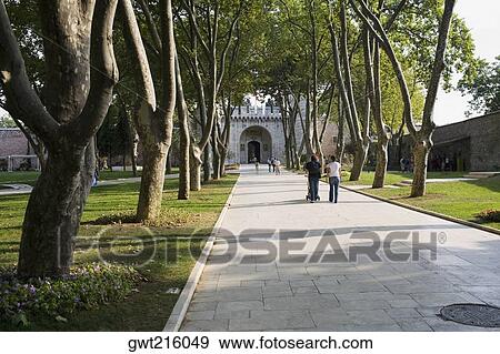 Rear view of two people walking towards a building, Istanbul, Turkey View Large Photo Image Stock Photo - Rear view of two people walking towards a building, Istanbul, Turkey. Fotosearch