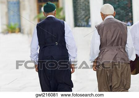 Rear view of two senior men walking together, Istanbul, Turkey View Large Photo Image Stock Image - Rear view of two senior men walking together, Istanbul, Turkey. Fotosearch
