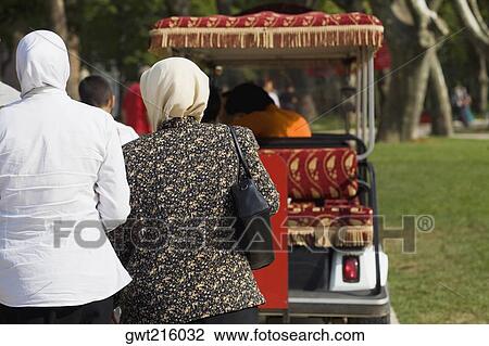 Rear view of two women standing behind a cart, Istanbul, Turkey View Large Photo Image Stock Image - Rear view of two women standing behind a cart, Istanbul, Turkey. Fotosearch