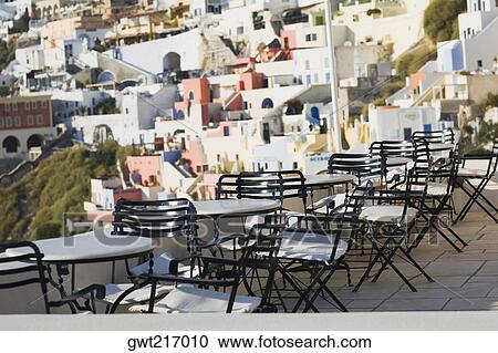 Empty chairs and tables in a restaurant, Greece View Large Photo Image Stock Image - Empty chairs and tables in a restaurant, Greece. Fotosearch