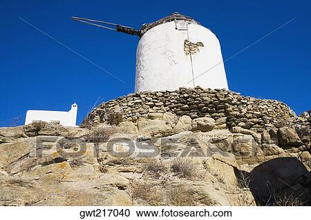 Stock Image - Low angle view of a traditional windmill, Mykonos, Cyclades Islands, Greece. Fotosearch