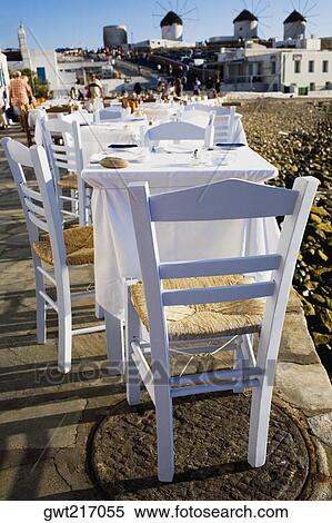 Tables and chairs in a restaurant, Mykonos, Cyclades Islands, Greece View Large Photo Image Stock Photography - Tables and chairs in a restaurant, Mykonos, Cyclades Islands, Greece. Fotosearch