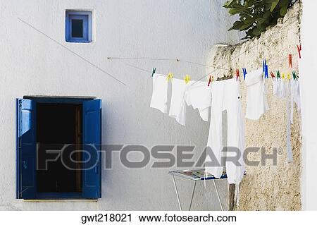 Clothes drying on a clothesline, Mykonos, Cyclades Islands, Greece View Large Photo Image Stock Image - Clothes drying on a clothesline, Mykonos, Cyclades Islands, Greece. Fotosearch