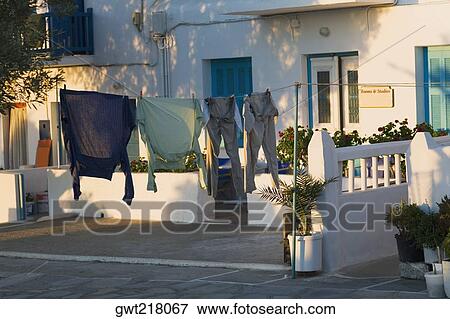 Clothes hanging on a clothesline, Mykonos, Cyclades Islands, Greece View Large Photo Image Stock Photo - Clothes hanging on a clothesline, Mykonos, Cyclades Islands, Greece. Fotosearch