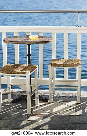Empty table with stools near a railing in a restaurant, Mykonos, Cyclades Islands, Greece View Large Photo Image Picture - Empty table with stools near a railing in a restaurant, Mykonos, Cyclades Islands, Greece. Fotosearch