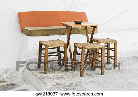 Empty table with three stools in a restaurant, Mykonos, Cyclades Islands, Greece View Large Photo Image Stock Photo - Empty table with three stools in a restaurant, Mykonos, Cyclades Islands, Greece. Fotosearch