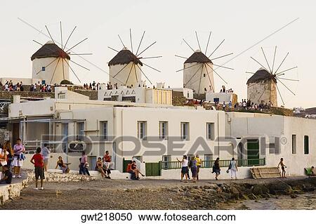 Large group of people in front of traditional windmills in a row, Mykonos, Cyclades Islands, Greece View Large Photo Image Stock Image - Large group of people in front of traditional windmills in a row, Mykonos, Cyclades Islands, Greece. Fotosearch