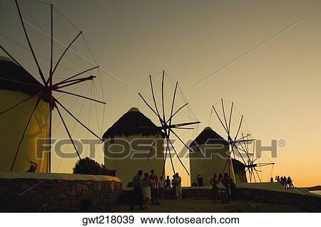 Low angle view of traditional windmills at dusk, Mykonos, Cyclades Islands, Greece View Large Photo Image Stock Photo - Low angle view of traditional windmills at dusk, Mykonos, Cyclades Islands, Greece. Fotosearch