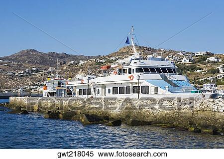 Passenger ship at a harbor, Mykonos, Cyclades Islands, Greece View Large Photo Image Stock Photography - Passenger ship at a harbor, Mykonos, Cyclades Islands, Greece. Fotosearch