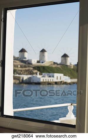 Traditional windmills viewed through a window, Mykonos, Cyclades Islands, Greece View Large Photo Image Picture - Traditional windmills viewed through a window, Mykonos, Cyclades Islands, Greece. Fotosearch