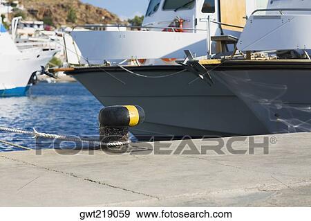 Yacht moored at a harbor, Patmos, Dodecanese Islands, Greece View Large Photo Image Stock Photo - Yacht moored at a harbor, Patmos, Dodecanese Islands, Greece. Fotosearch