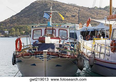 Stock Image - Yachts moored at a harbor, Skala, Patmos, Dodecanese Islands, Greece. Fotosearch