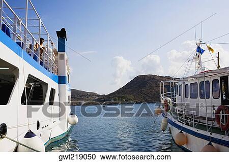 Yachts moored at a harbor, Skala, Patmos, Dodecanese Islands, Greece View Large Photo Image Stock Image - Yachts moored at a harbor, Skala, Patmos, Dodecanese Islands, Greece. Fotosearch