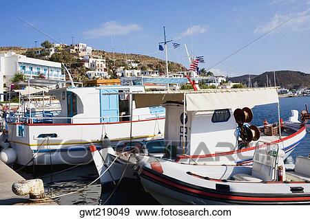 Yachts moored at a harbor, Skala, Patmos, Dodecanese Islands, Greece View Large Photo Image Stock Photo - Yachts moored at a harbor, Skala, Patmos, Dodecanese Islands, Greece. Fotosearch