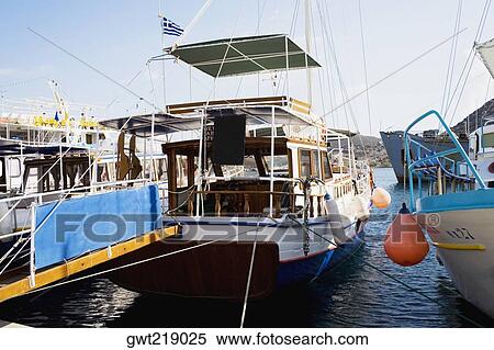 Yachts moored at a harbor, Skala, Patmos, Dodecanese Islands, Greece View Large Photo Image Stock Photography - Yachts moored at a harbor, Skala, Patmos, Dodecanese Islands, Greece. Fotosearch