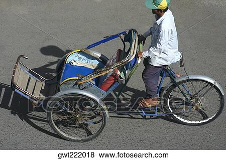 High angle view of a man riding a pedicab, Sihanoukville, Cambodia View Large Photo Image Stock Photo - High angle view of a man riding a pedicab, Sihanoukville, Cambodia. Fotosearch