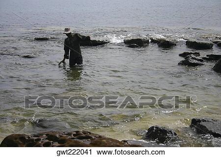 Rear view of a man fishing, Sihanoukville, Cambodia View Large Photo Image Stock Image - Rear view of a man fishing, Sihanoukville, Cambodia. Fotosearch