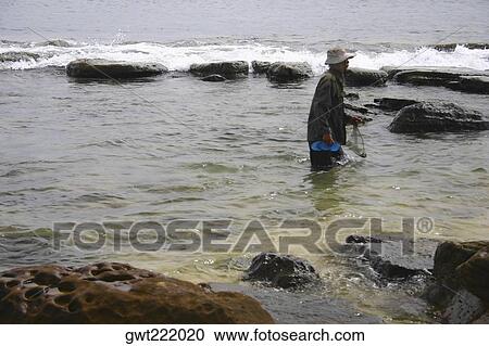 Side profile of a man fishing, Sihanoukville, Cambodia View Large Photo Image Stock Image - Side profile of a man fishing, Sihanoukville, Cambodia. Fotosearch