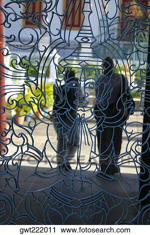 Two people standing behind the grill of a palace, Royal Palace, Phnom Penh, Cambodia View Large Photo Image Stock Image - Two people standing behind the grill of a palace, Royal Palace, Phnom Penh, Cambodia. Fotosearch
