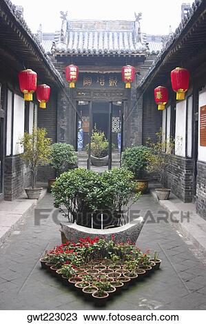 Stock Image - Chinese lanterns hanging in the courtyard of a building, Pingyao, Shaanxi Province, China. Fotosearch
