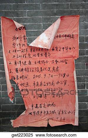 Stock Photography - Close-up of a torn poster on a wall, Pingyao, Shaanxi Province, China. Fotosearch
