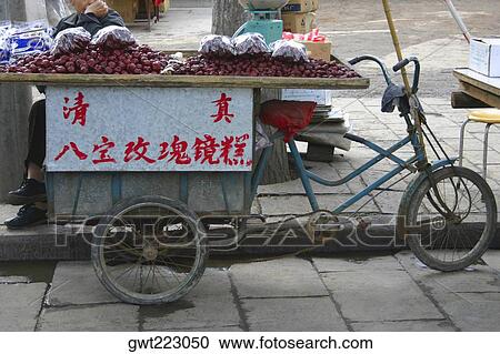 Market vendor selling plums at the roadside, Xi'an, Shaanxi Province, China View Large Photo Image Stock Image - Market vendor selling plums at the roadside, Xi'an, Shaanxi Province, China. Fotosearch