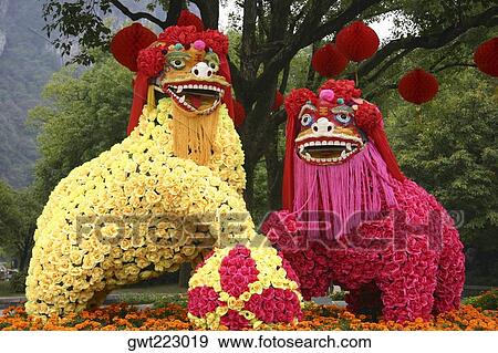 Statues of two dragons covered with flowers, Yungang Buddhist Caves, China View Large Photo Image Stock Photo - Statues of two dragons covered with flowers, Yungang Buddhist Caves, China. Fotosearch