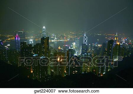High angle view of skyscrapers lit up at night in a city, Victoria Harbor, Hong Kong Island, Hong Kong, China View Large Photo Image Stock Photo - High angle view of skyscrapers lit up at night in a city, Victoria Harbor, Hong Kong Island, Hong Kong, China. Fotosearch
