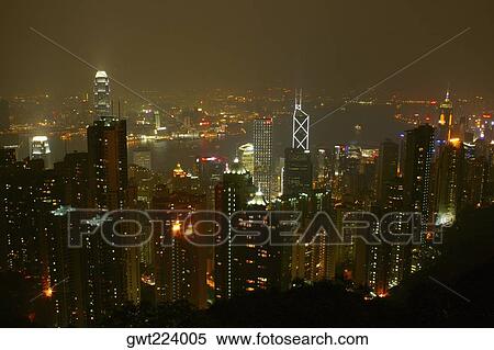 High angle view of skyscrapers lit up at night in a city, Victoria Harbor, Hong Kong Island, Hong Kong, China View Large Photo Image Stock Photography - High angle view of skyscrapers lit up at night in a city, Victoria Harbor, Hong Kong Island, Hong Kong, China. Fotosearch
