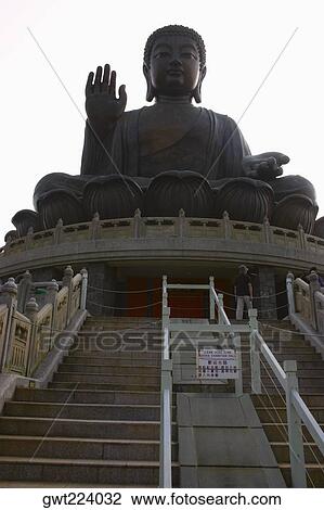 Low angle view of a statue of Buddha, Tian Tan Buddha, Po Lin Monastery, Ngong Ping, Lantau, Hong Kong, China View Large Photo Image Stock Image - Low angle view of a statue of Buddha, Tian Tan Buddha, Po Lin Monastery, Ngong Ping, Lantau, Hong Kong, China. Fotosearch