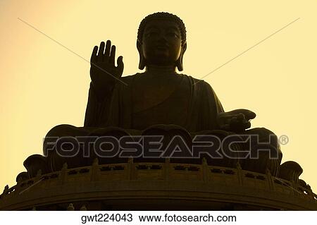 Stock Image - Low angle view of a statue of Buddha, Tian Tan Buddha, Po Lin Monastery, Ngong Ping, Lantau, Hong Kong, China. Fotosearch