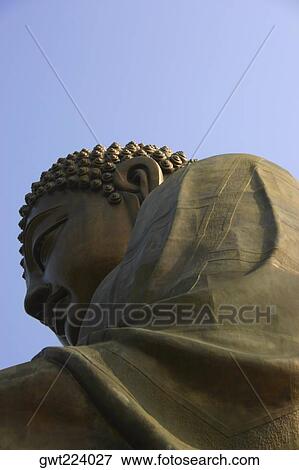 Stock Photo - Low angle view of a statue of Buddha, Tian Tan Buddha, Po Lin Monastery, Ngong Ping, Lantau, Hong Kong, China. Fotosearch