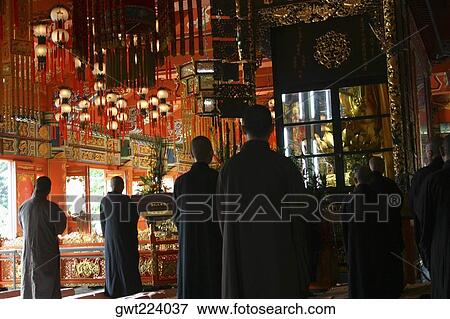 Stock Photo - Rear view of a group of people praying in a monastery, Po Lin Monastery, Ngong Ping, Lantau, Hong Kong, China. Fotosearch