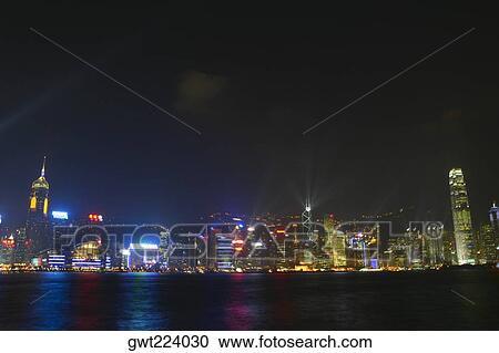 Skyscrapers lit up at night in a city, Victoria Harbor, Hong Kong Island, Hong Kong, China View Large Photo Image Stock Image - Skyscrapers lit up at night in a city, Victoria Harbor, Hong Kong Island, Hong Kong, China. Fotosearch