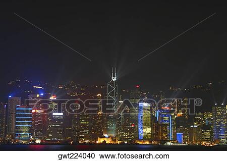 Skyscrapers lit up at night in a city, Victoria Harbor, Hong Kong Island, Hong Kong, China View Large Photo Image Stock Image - Skyscrapers lit up at night in a city, Victoria Harbor, Hong Kong Island, Hong Kong, China. Fotosearch