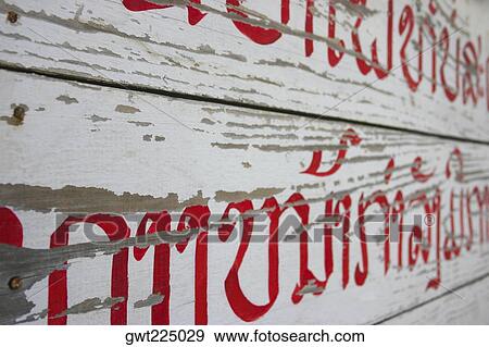Stock Photo - Close-up of a non-western script on a wood, Luang Prabang, Laos. Fotosearch