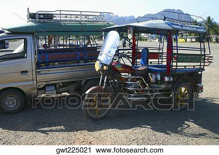 Jinrikisha and a truck parked at roadside, Vang Vieng, Laos View Large Photo Image Stock Image - Jinrikisha and a truck parked at roadside, Vang Vieng, Laos. Fotosearch