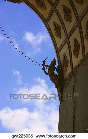 Stock Photography - Low angle view of a statue on a wall of an archway, Victoria Memorial, Laos. Fotosearch