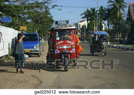Passengers traveling in a jinrikisha, Luang Prabang, Laos View Large Photo Image Stock Image - Passengers traveling in a jinrikisha, Luang Prabang, Laos. Fotosearch
