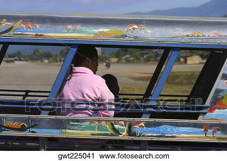 Passengers traveling in a jinrikisha, Vang Vieng, Laos View Large Photo Image Stock Image - Passengers traveling in a jinrikisha, Vang Vieng, Laos. Fotosearch